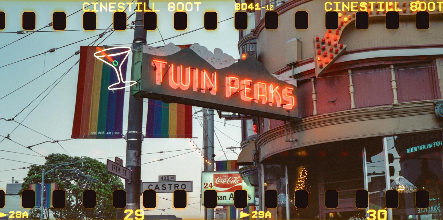 A neon sign for "Twin Peaks" is visible above a street sign for Castro Street.