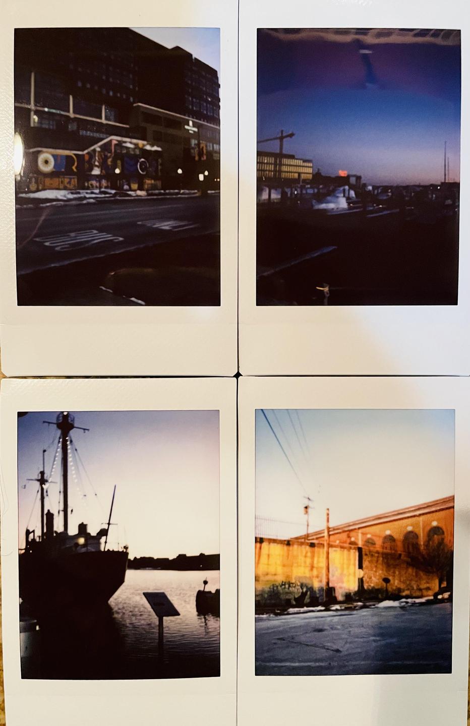 Four instant photos show different views of Baltimore, including a street with a building and a boat on the water.