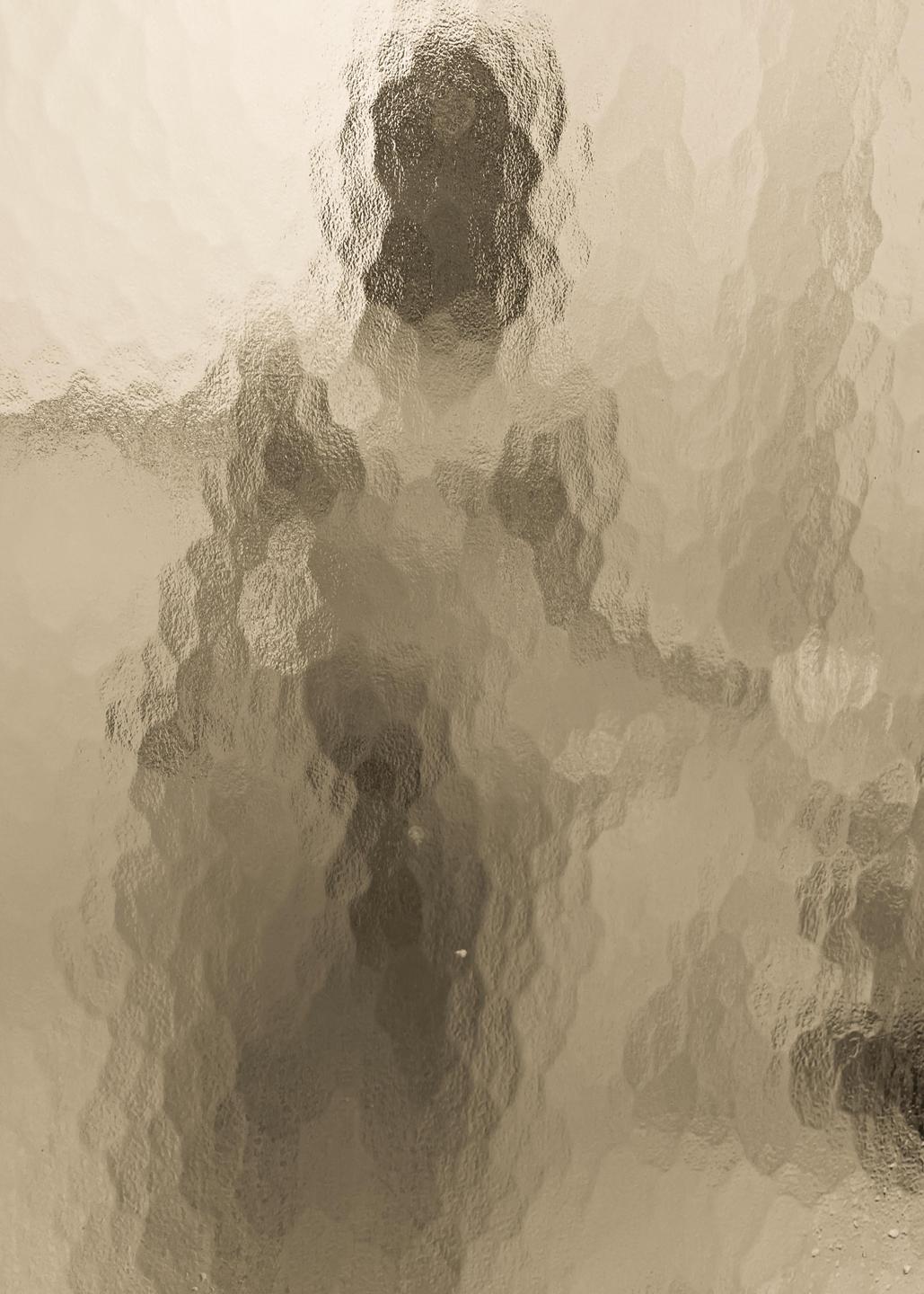 A figure is visible through textured glass.