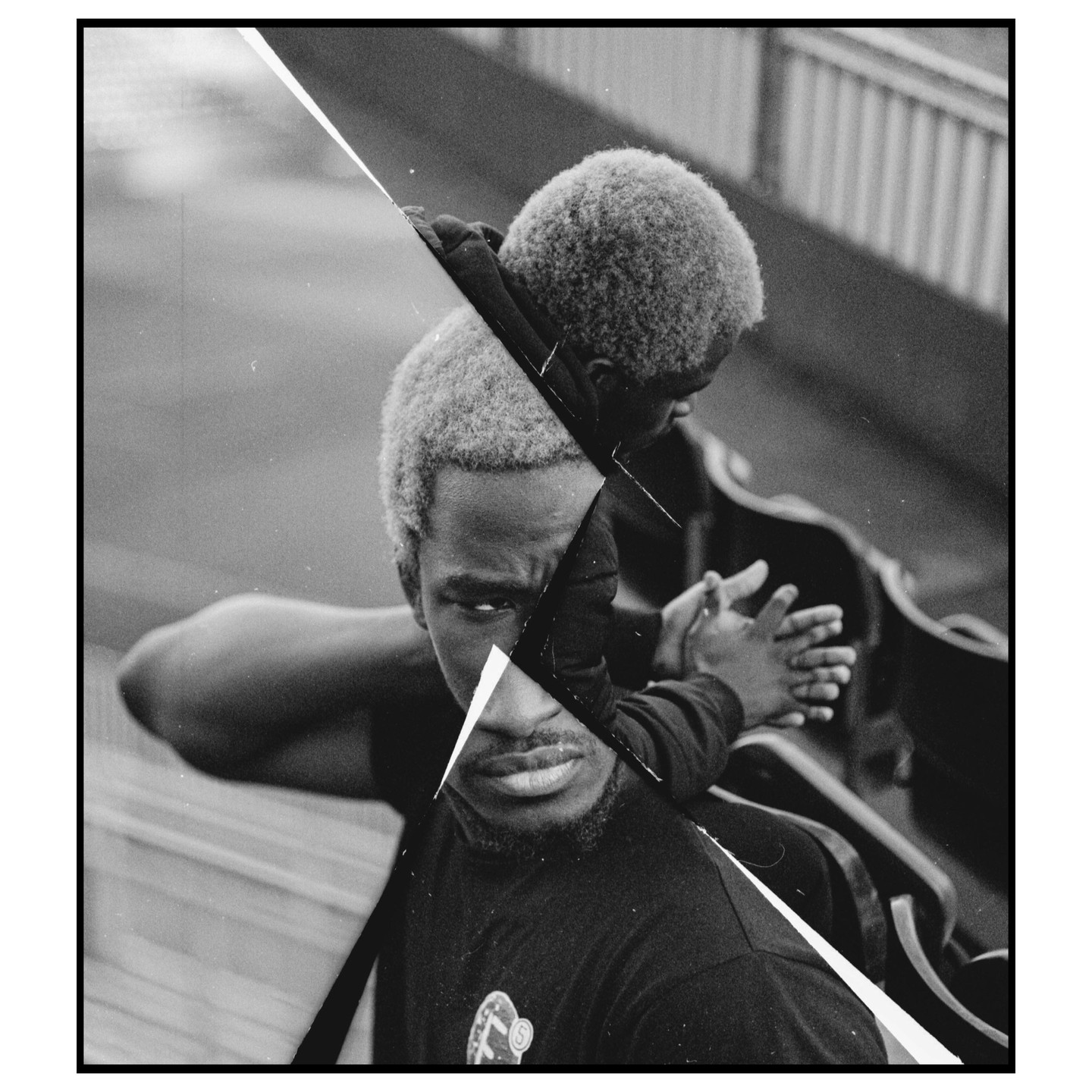 A man with light hair and a beard looks at the viewer while a child with light hair sits behind him, both images split by a diagonal line.