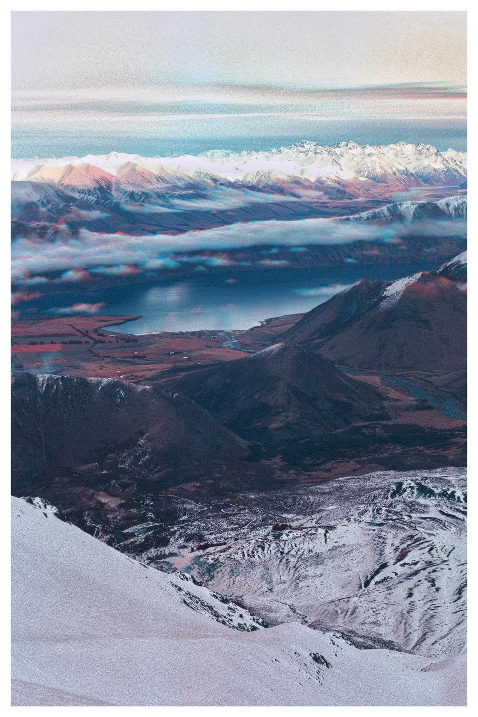 A vast mountain landscape with a lake and clouds is visible from a high vantage point.