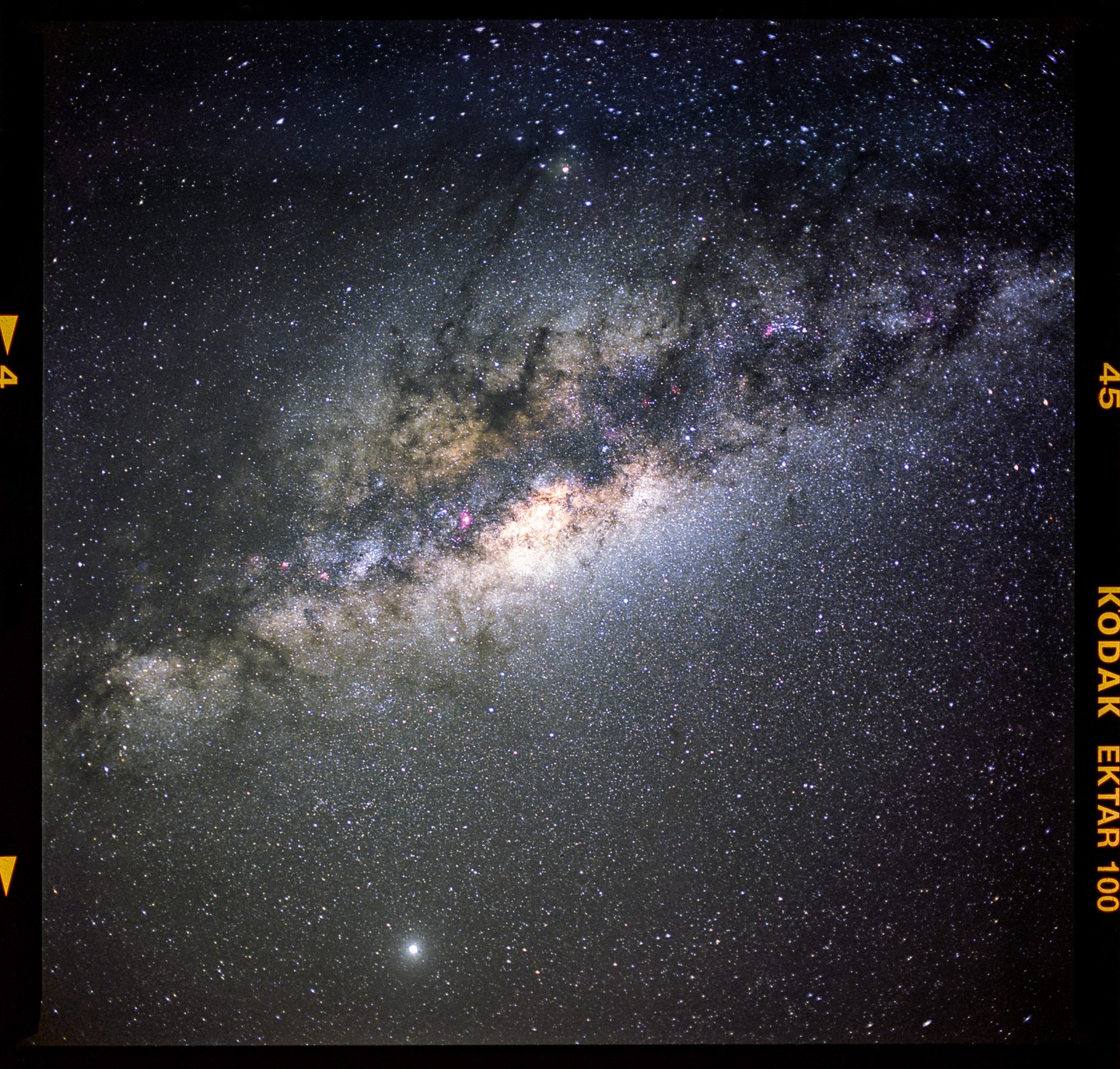 The Milky Way core is visible in the night sky with a bright planet below it.