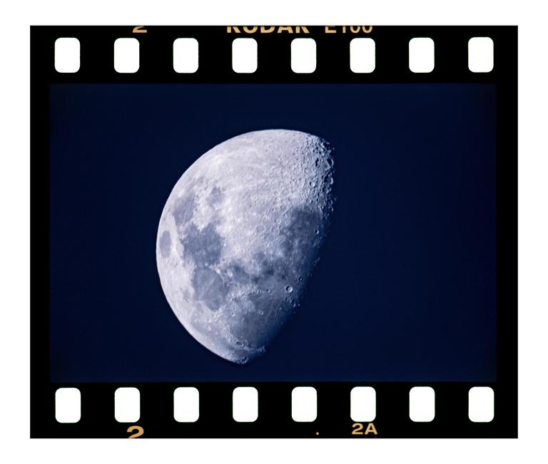 A detailed view of the moon, showing its craters and texture, is captured against a dark sky.