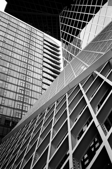 A low-angle view shows the geometric patterns of several modern buildings, including the Seattle Public Library.