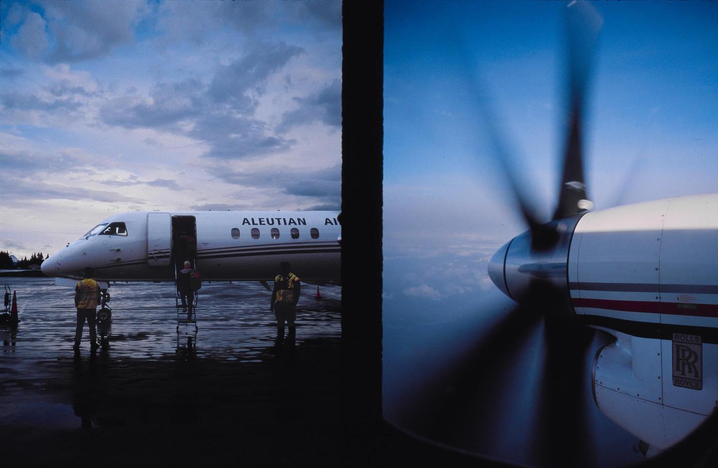 A diptych shows an airplane on a wet tarmac with people and a propeller in motion against a blue sky.