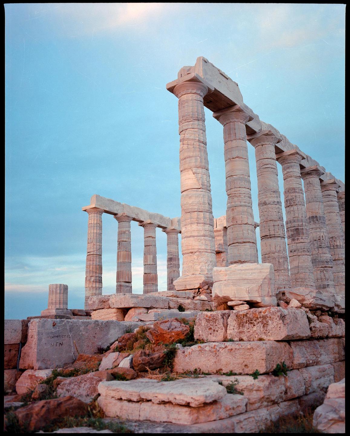The Temple of Poseidon stands against a clear sky.