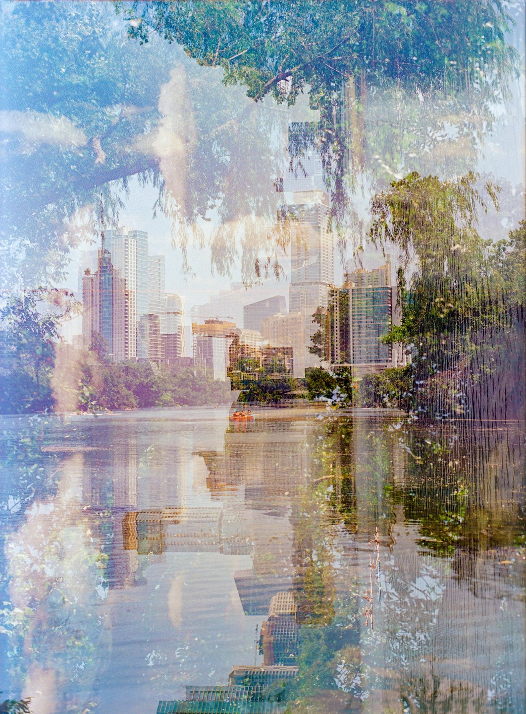 A quadruple exposure shows a city skyline and trees reflected in a body of water.