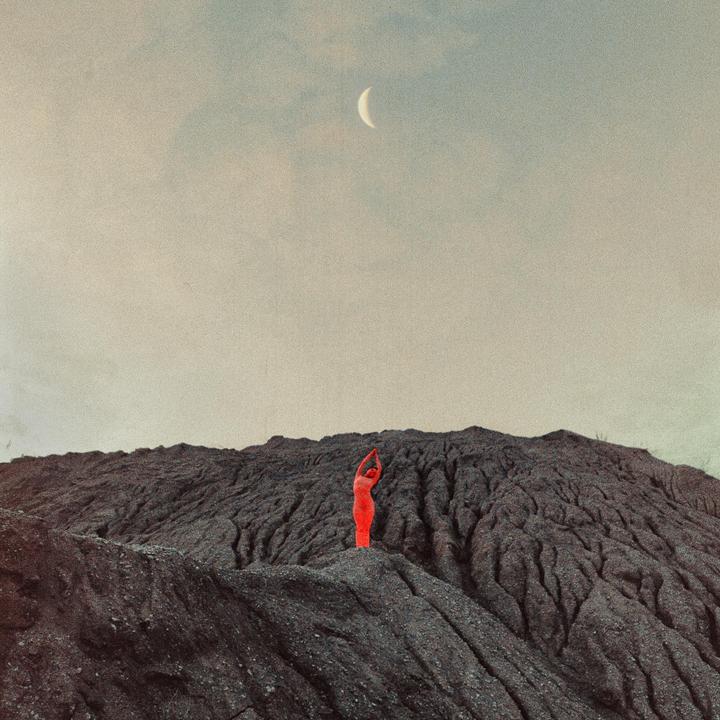 A person in a red suit stands on a dark, textured hill under a cloudy sky with a crescent moon.