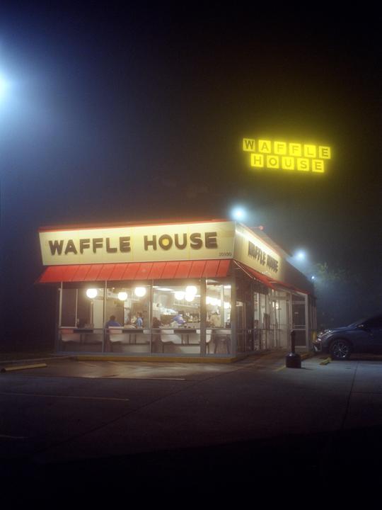 A Waffle House restaurant is illuminated at night, with a bright Waffle House sign visible above the building.