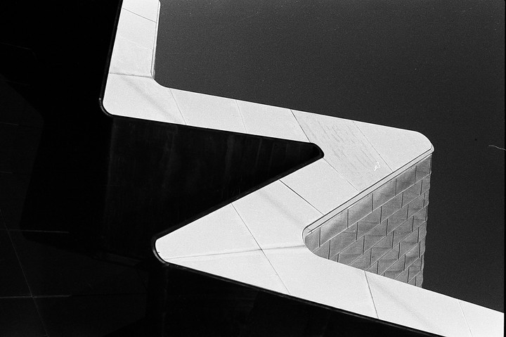 A black and white abstract image shows a zigzagging white line against a dark background.