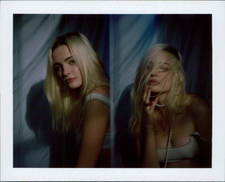 A woman with long blonde hair and a pearl necklace is shown in a double exposure, with one image of her looking at the camera and the other with her hair covering her face.