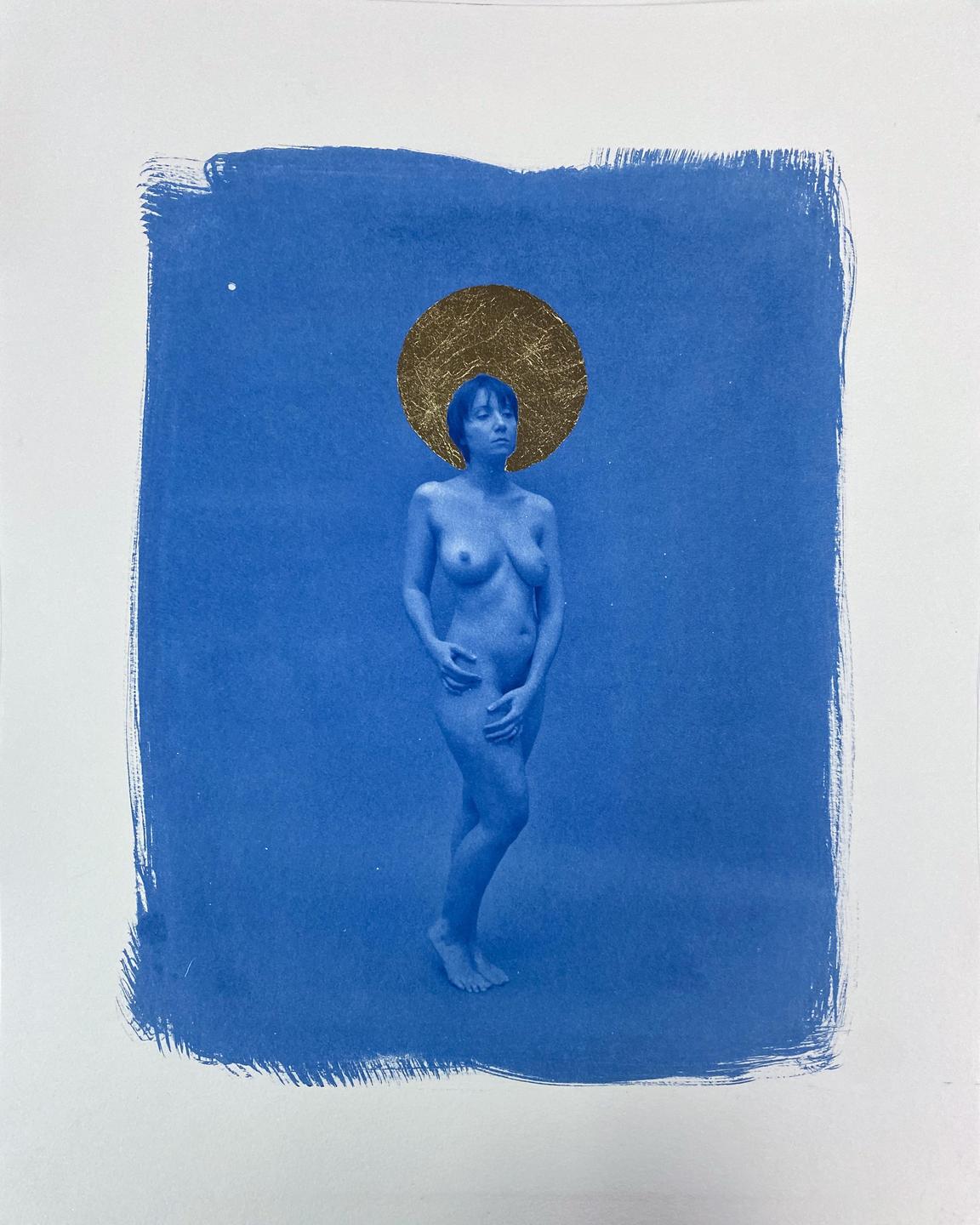 A nude woman stands with a gold leaf halo against a blue background.