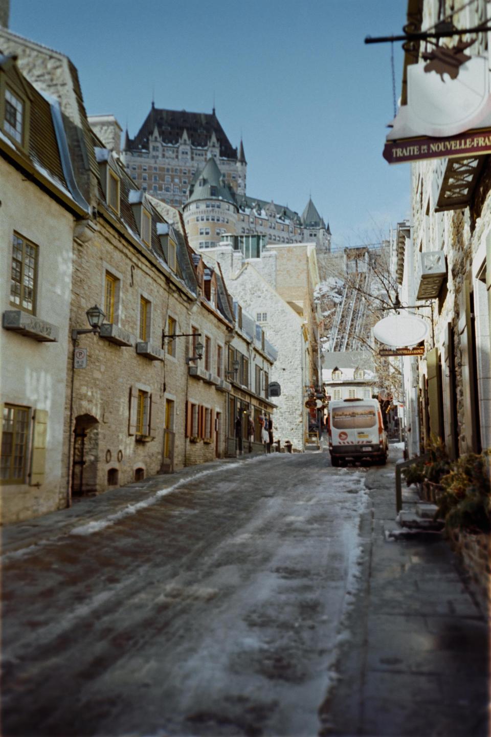 A snow-dusted street in Quebec City leads up to the Château Frontenac.