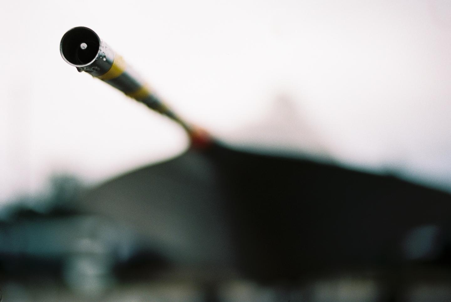 A pitot tube with yellow and black stripes is visible in the foreground, with a blurred aircraft in the background.