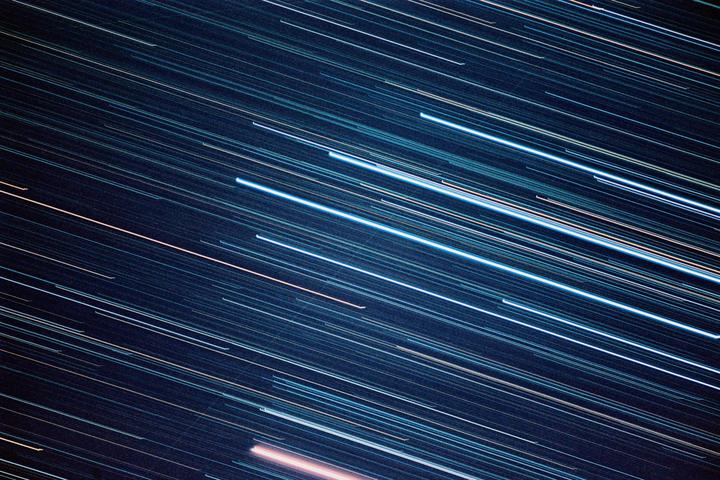 Streaks of light from stars are visible against a dark night sky.