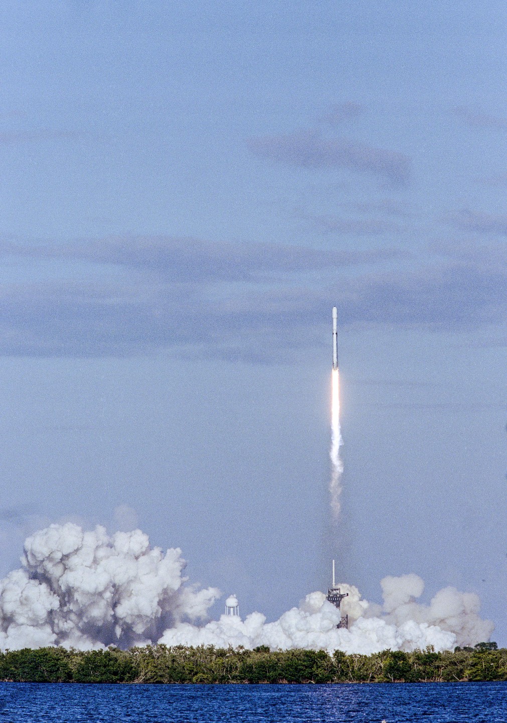 A rocket launches into the sky, leaving a trail of smoke and fire behind it.
