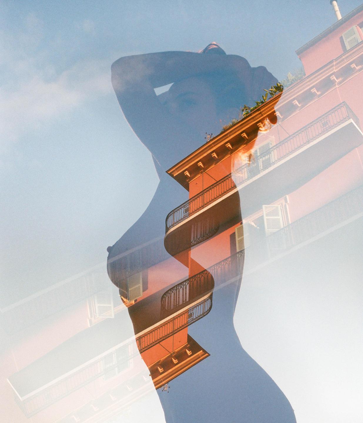 A triple exposure shows the silhouette of a woman overlaid with a building and a blue sky.