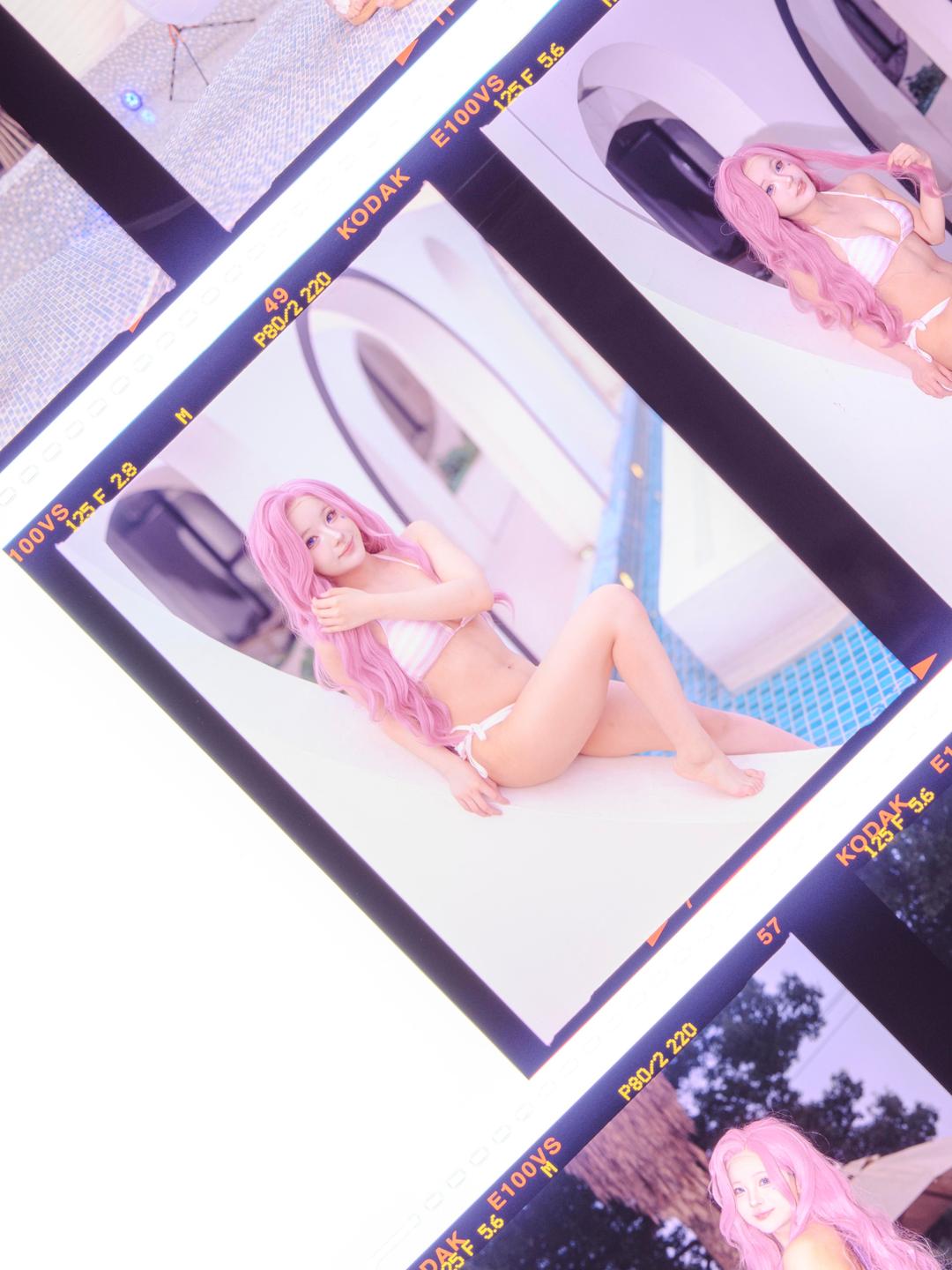 A woman with pink hair in a bikini is visible in multiple frames of a film strip.
