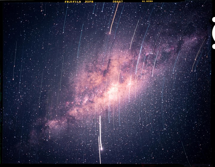 The Milky Way is visible in the night sky with many star trails.