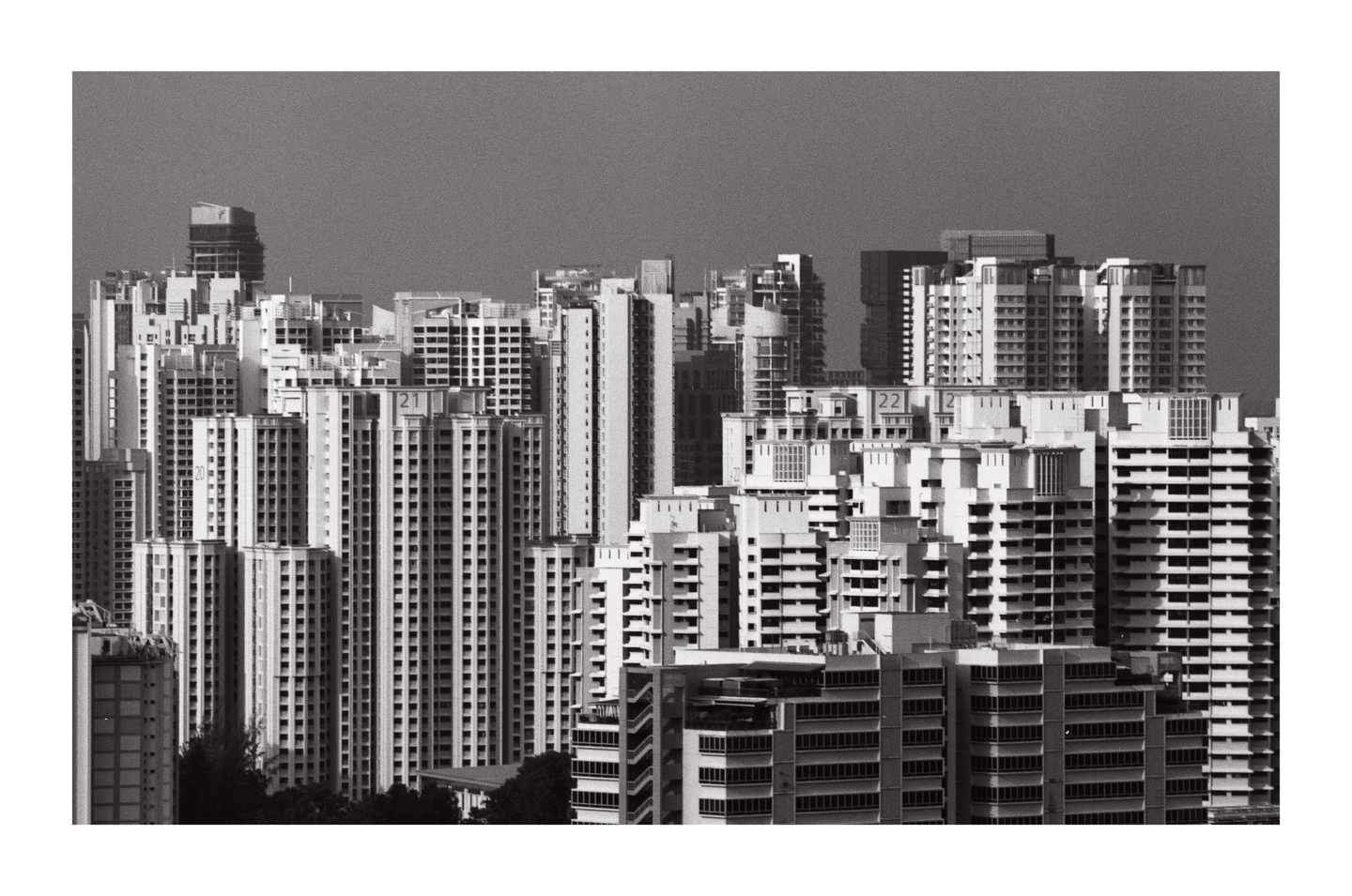 A dense cluster of high-rise buildings fills the frame under a clear sky.