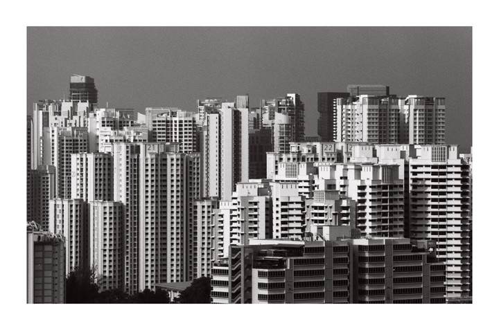 A dense cluster of high-rise buildings fills the frame under a clear sky.