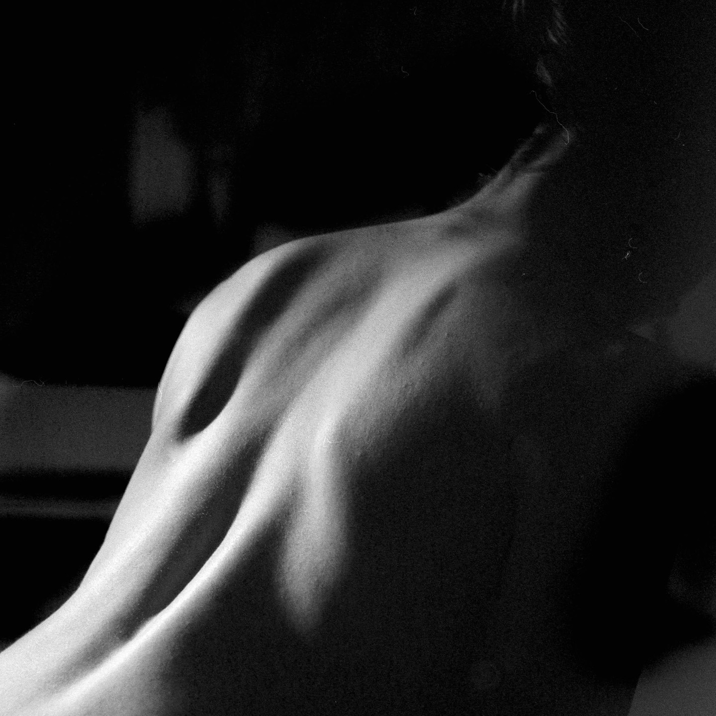 The back of a person is visible in a black and white close-up.