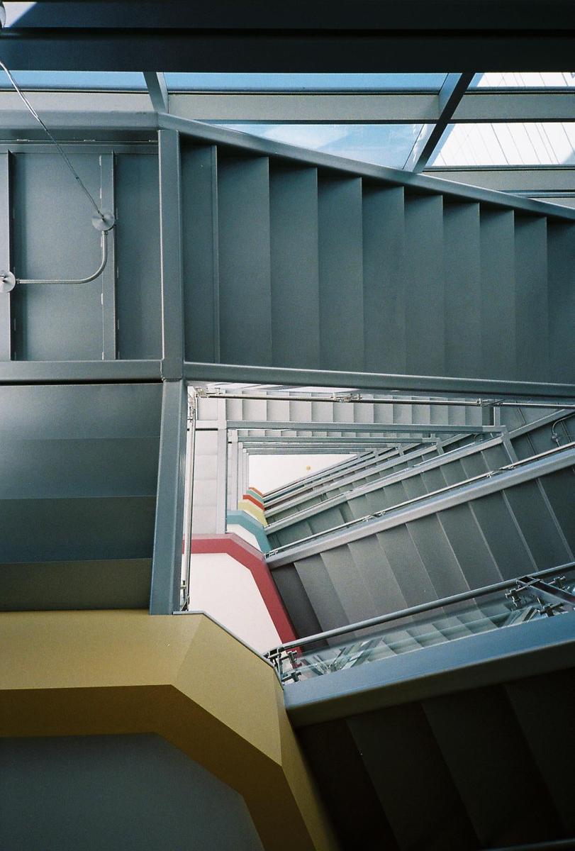 A multi-story staircase with colorful walls is visible from above.