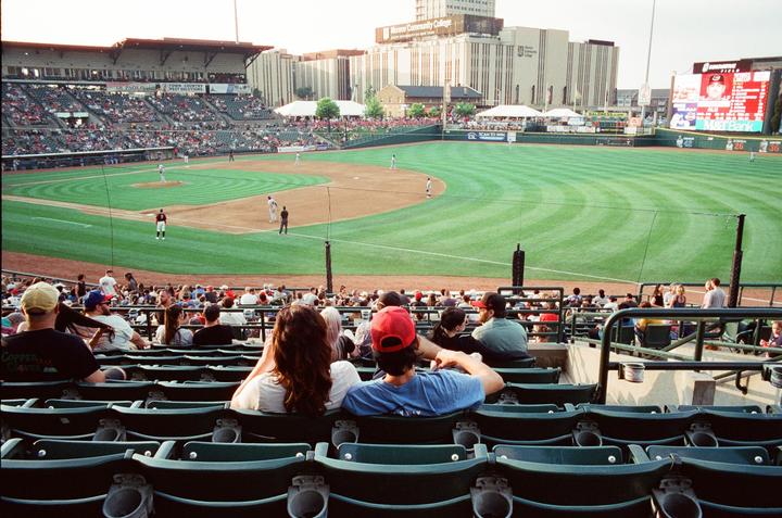 A baseball game is in progress at a stadium with many spectators in the stands.