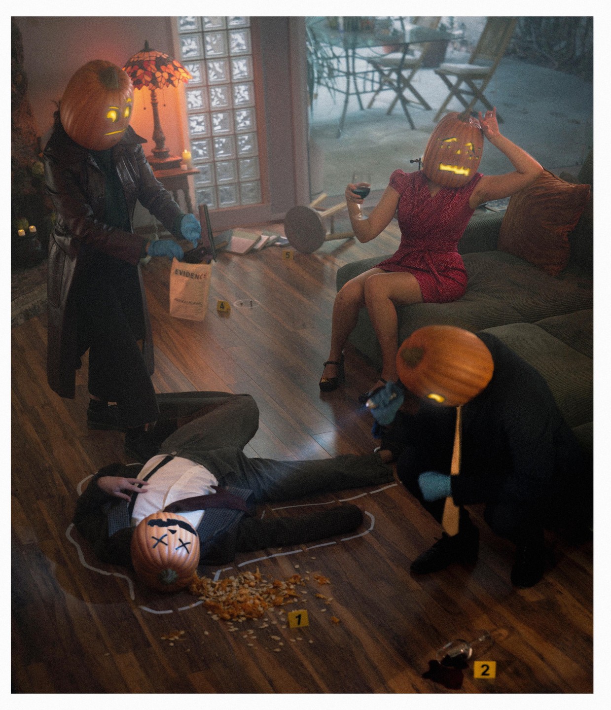 Four people with pumpkin heads are in a room, three of them investigating a "murder" of a fourth person lying on the floor, outlined in chalk.
