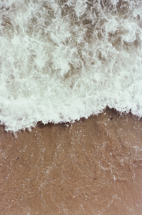 Waves crash onto the sand at Santa Monica Pier.