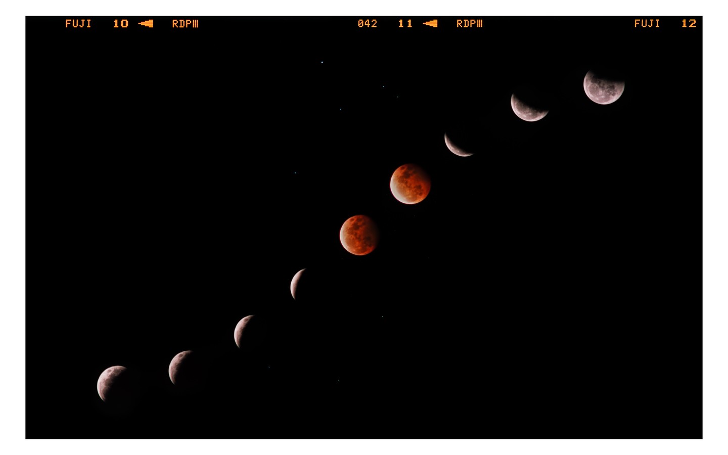 A sequence of moon phases, including a red lunar eclipse, is visible against a dark night sky.