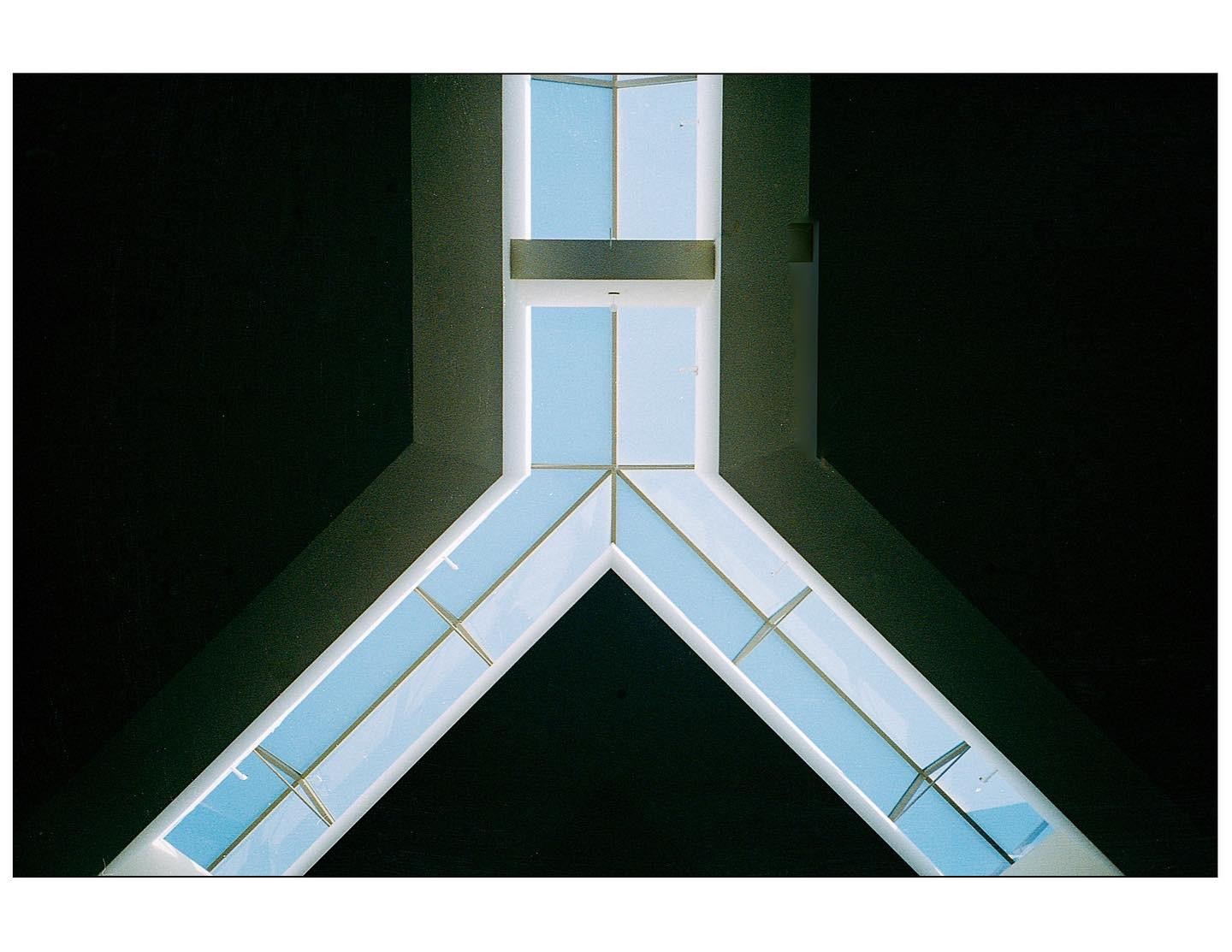 A skylight with a geometric pattern is visible against a dark ceiling.