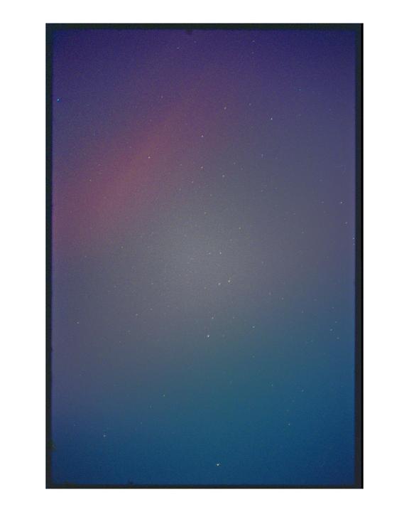 The night sky is filled with stars and a colorful aurora.