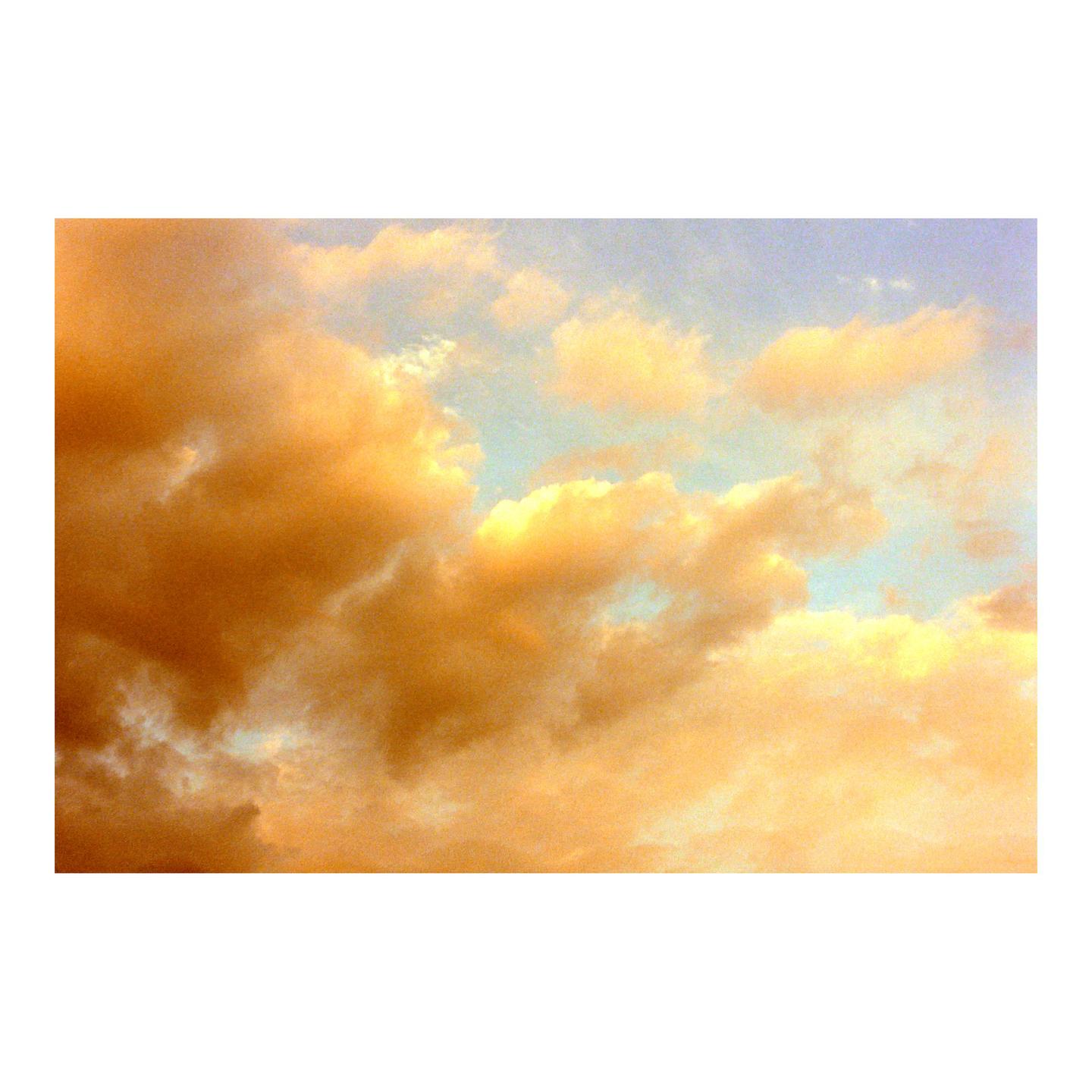 Golden clouds fill the sky with patches of blue visible between them.