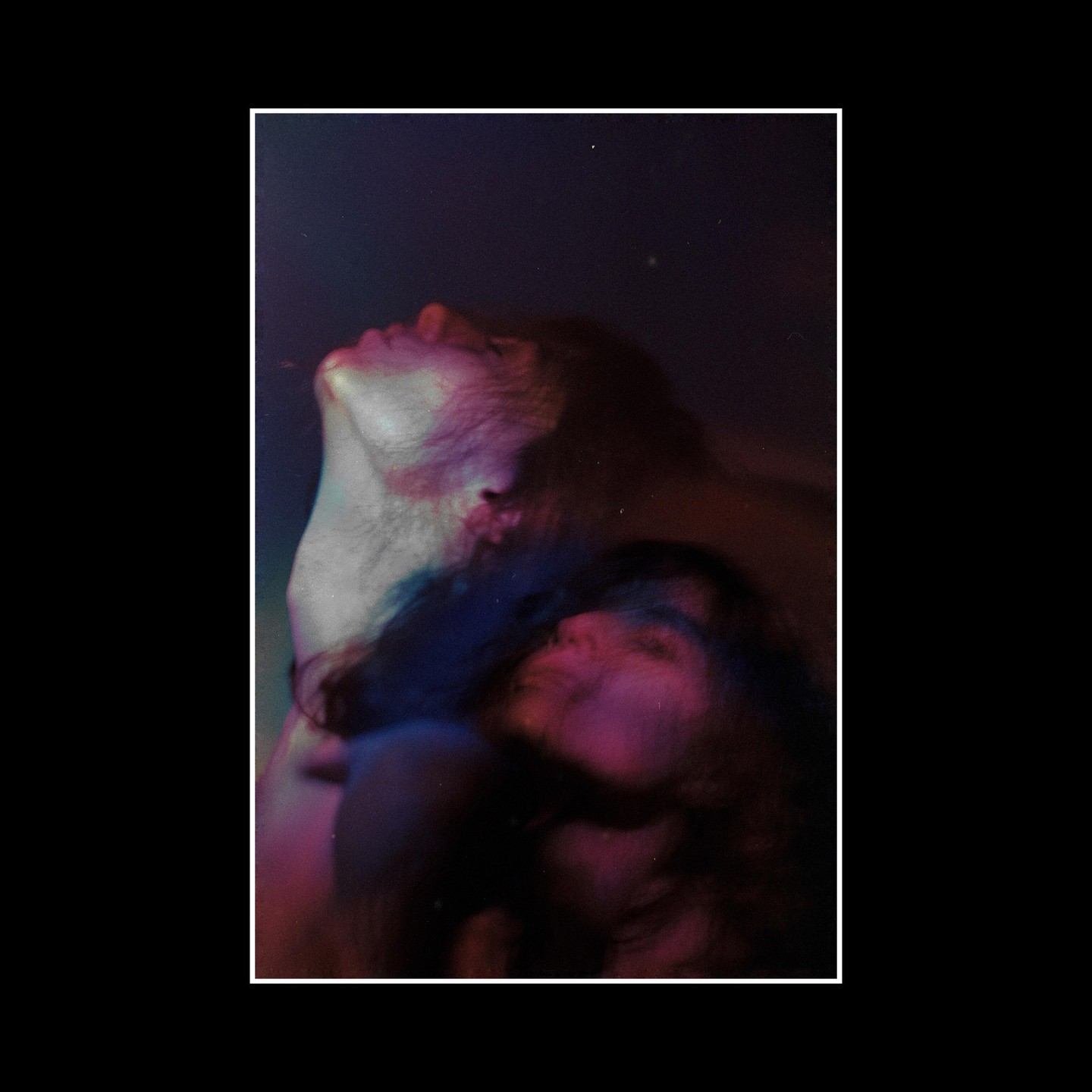 A double exposure shows a man looking up and a woman looking down, both with colorful light on their faces.