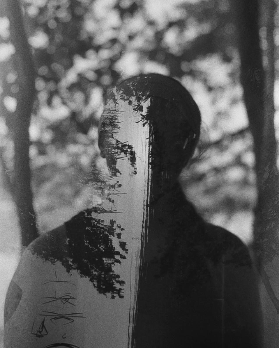 A double exposure shows a woman's silhouette overlaid with a forest scene.