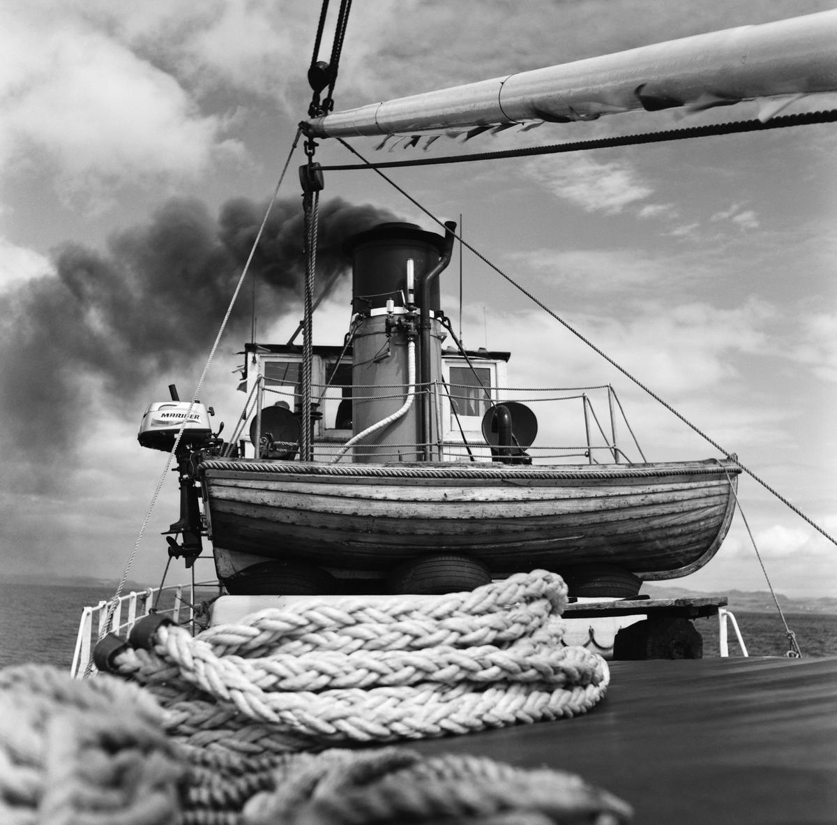 A small boat is visible on the deck of a steamship, with smoke billowing from its funnel.