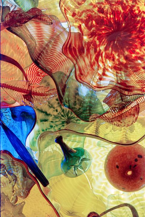 A colorful glass sculpture with organic shapes and patterns is visible.