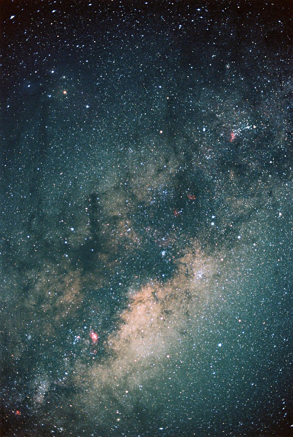 The Milky Way is visible in the night sky, with many stars and some nebulae.