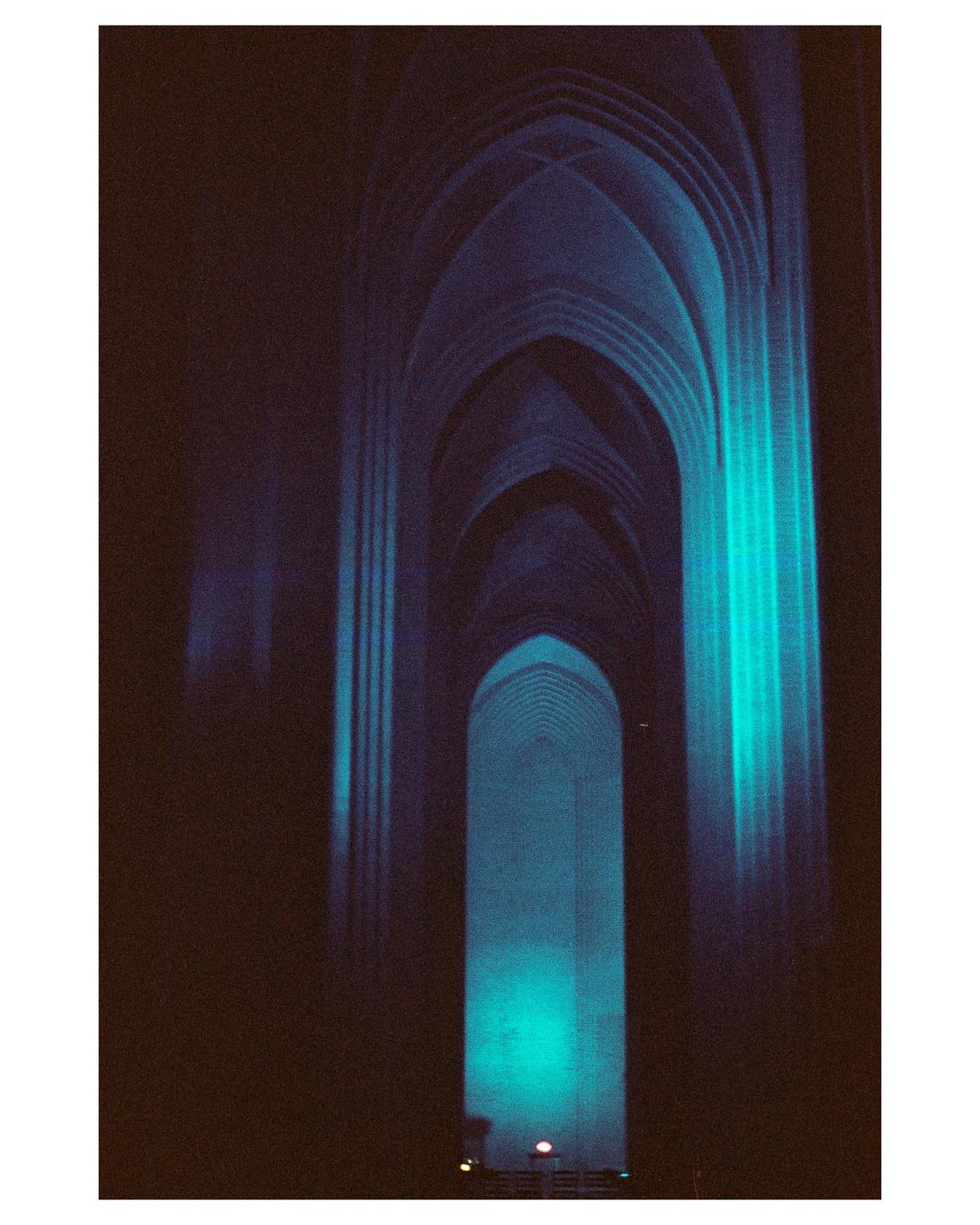 A series of illuminated arches recede into the distance, creating a tunnel effect.