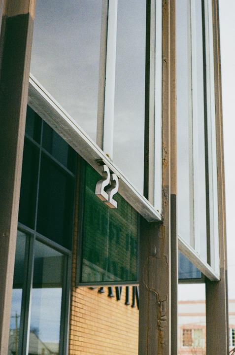 The number 22 is affixed to the side of a building with large windows.