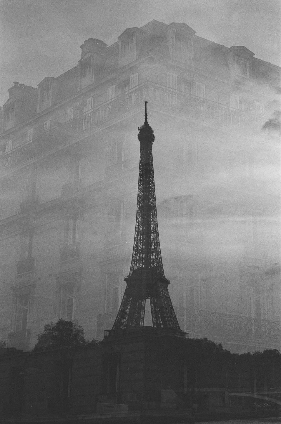 A double exposure shows the Eiffel Tower superimposed over a building in Paris.