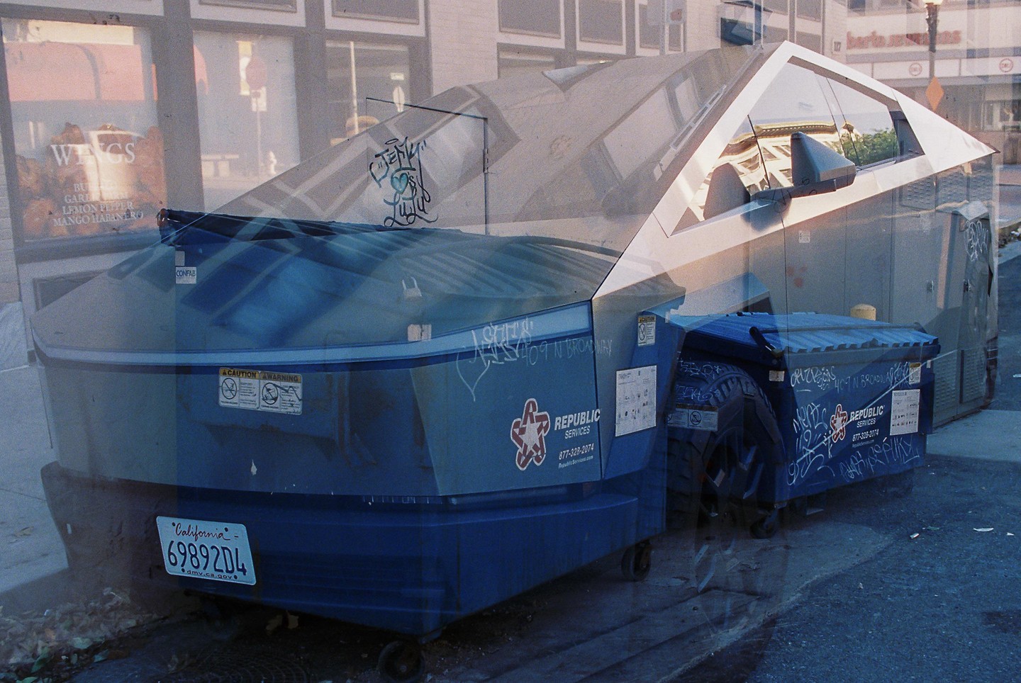A double exposure shows a blue dumpster with graffiti and a California license plate superimposed over a vehicle.
