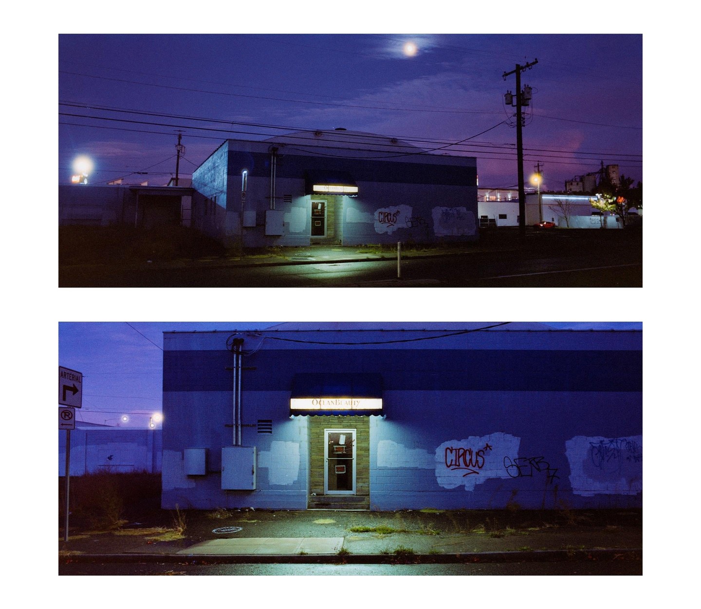 A blue building with a sign that reads "Ocean Beauty" is illuminated by a light above its door at night.
