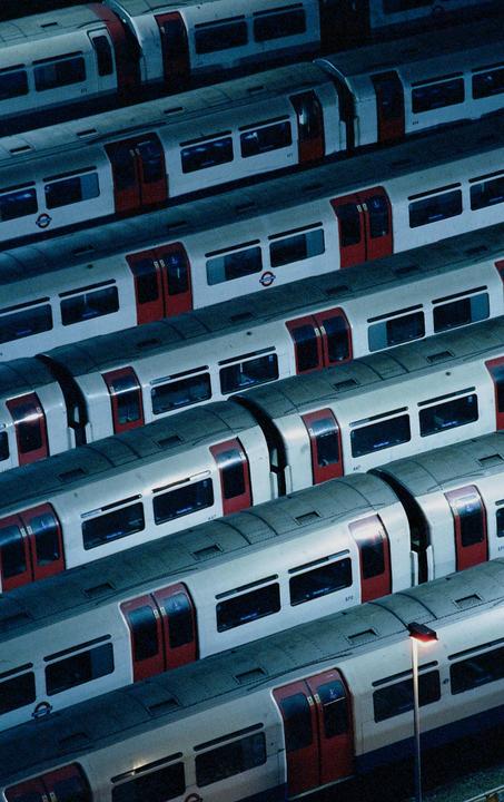 Several subway trains are parked side by side, viewed from above at night.