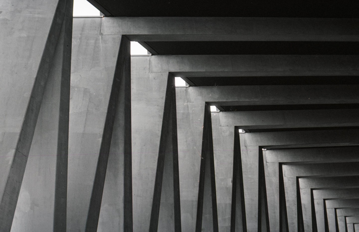 A series of concrete beams and columns recede into the distance, creating a repeating pattern.