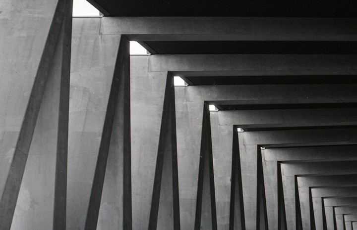 A series of concrete beams and columns recede into the distance, creating a repeating pattern.
