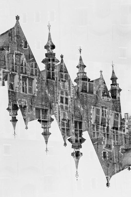 A double exposure shows the gabled facades and spires of buildings in Bruges.