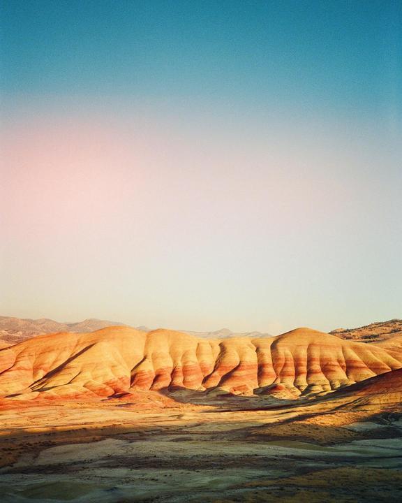 The Painted Hills are visible under a clear sky.