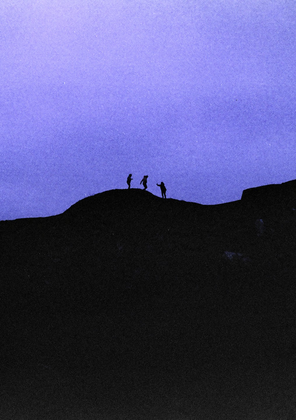 Three children are silhouetted against a purple sky, standing on a dark hill.